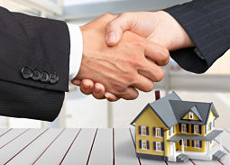 shaking-hands-with-small-house-in-background-lake-county-attorney shaking hands with small house in background, lake county attorney